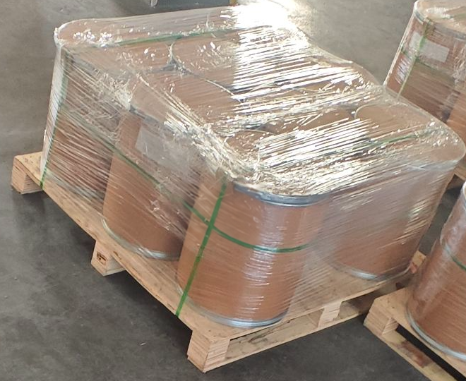 Wrapped drums on a wooden pallet in a real supply setting